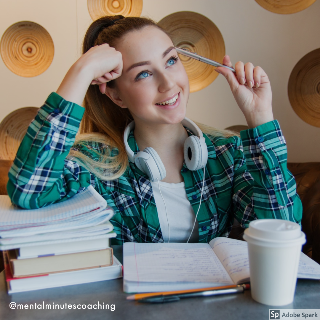 college girl studying with pile of books